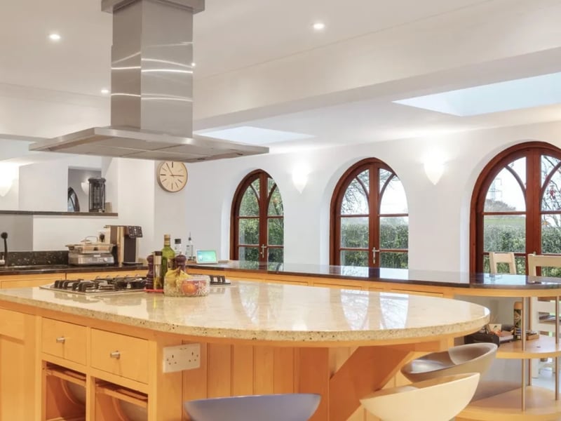 This home comes with five bedrooms, five bathrooms, three reception rooms, an indoor swimming pool, a tennis court and parking. 