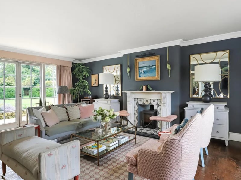The listing says: "Built in the Georgian style in the 1960s, with more recent additions, the house is classically proportioned with light rooms, large sash windows and high ceilings." 