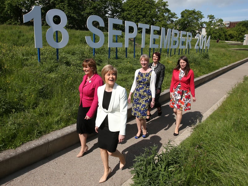 Deputy First Minister Nicola Sturgeon (second left) with some female members of the Scottish Cabinet, as they walk past an '18 September 2014' sign outside the Scottish Parliament, as there are 100 days to go until the referendum.