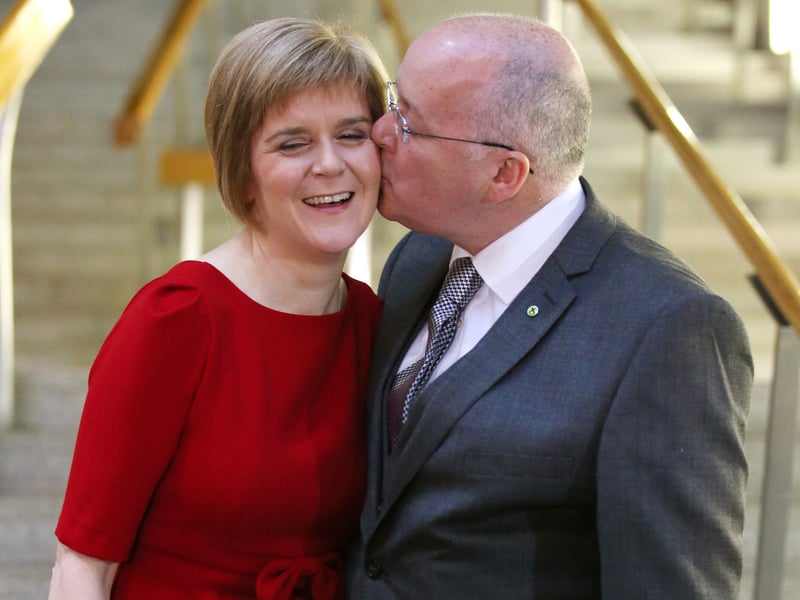 The-then SNP leader Nicola Sturgeon is given a kiss by her husband Peter Murrell at the Scottish Parliament in Edinburgh, after she was voted in as First Minister of Scotland in 2014. 