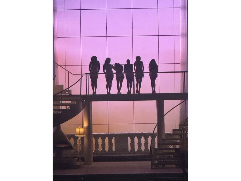 Sabrina and her dancers in silhouette.