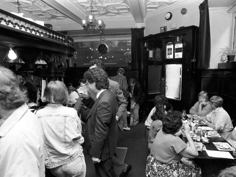 People having a drink and a bar meal at the Abbotsford pub in Rose Street Edinburgh, August 1987.