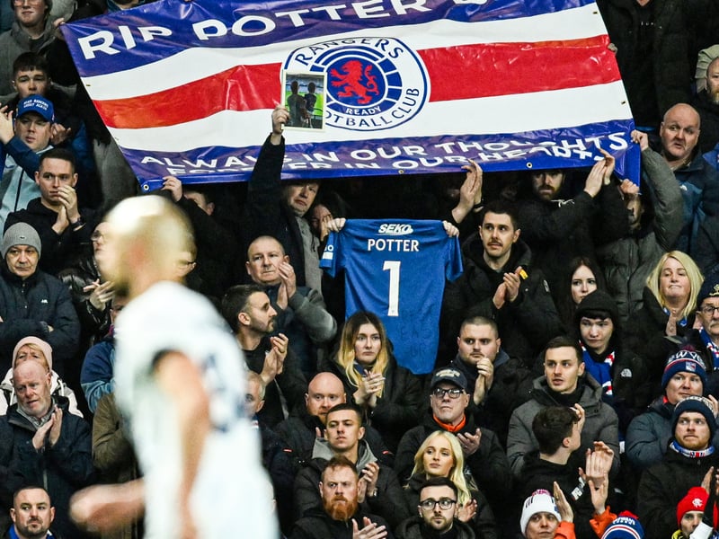 Rangers fans hold up a banner and a shirt in memory of Rangers fan Christopher Potter who died in Turkey last week.