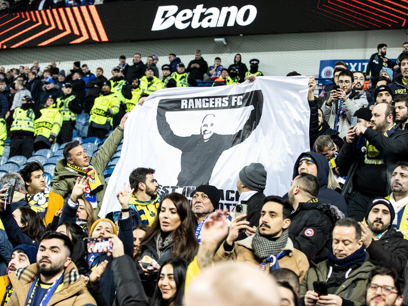 Fenerbahce fans hold up a flag in memory of Rangers fan Christopher Potter