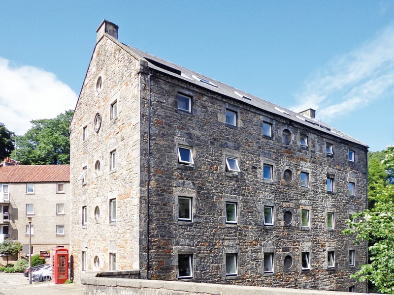 This is the only mill remaining of 11 once operated along the Water of Leith by The Incorporation of Baxters (bakers), one of the city’s trades guilds.
On the gable, the incorporation's wheat sheaf symbol can be seen and above the door is an eroded panel decorated with bakers’ utensils, a sheaf of corn, cherubs and an inscription: ‘God bless the Baxters of Edinburgh who built this House 1675.’
It was converted into flats in the 1970s.
