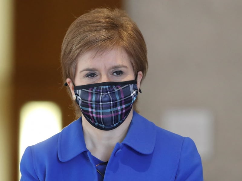 A masked First Minister arrives at the Scottish Parliament to make her latest lockdown announcement.