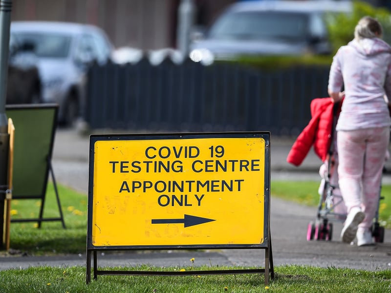 A woman walks past a covid -19 testing centre sign in Grangemouth.