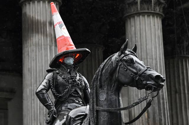 The Duke of Wellington statue outside the Gallery of Modern Art wears a face mask.