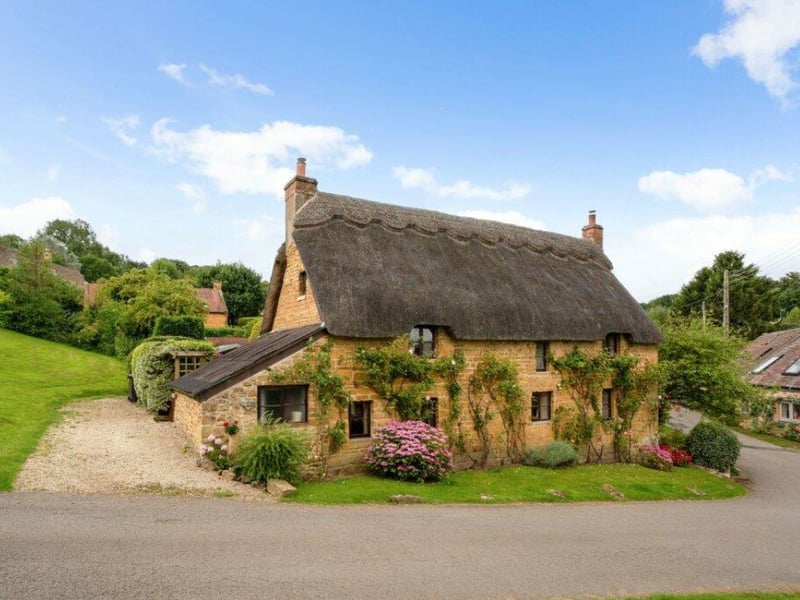 Ilmington in the Cotswolds, Warwickshire, is the best place to live in the Midlands, according to the Sunday Times. Judges called it 'pretty as a picture' and a 'blissful example of village life as it should be. It boasts good pubs, sports clubs and community groups, with the beating heart of the village being the volunteer-run community shop. This gorgeous thatched cottage overlooks the village green in the charming neighbourhood, with its village shop/cafe and two popular pubs. The three-bedroom Grade II-listed cottage boasts a wealth of original period features.