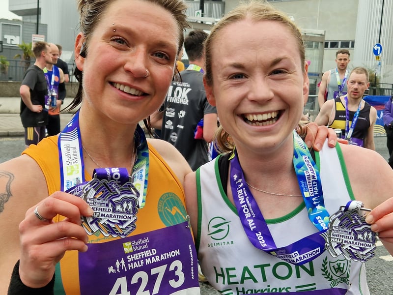 Two runners celebrate completing the race and picking up their medals. Photo: David Kessen, National World