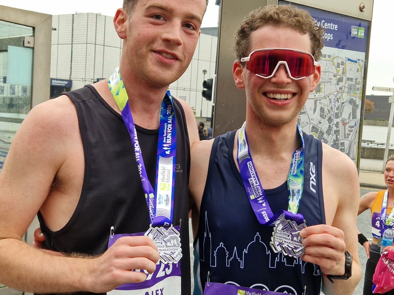Two runners display their medals after completing the race. Photo: David Kessen, National World