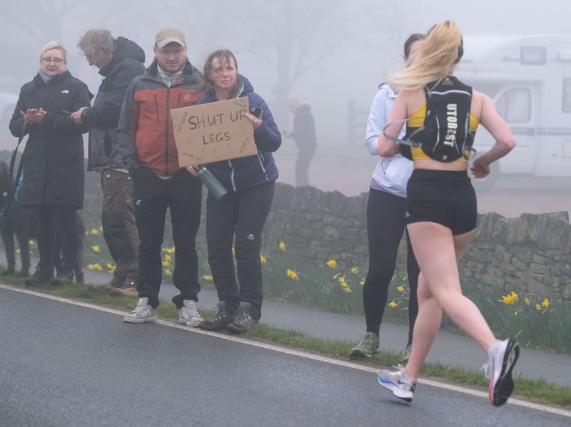 Spectators with a supportive message for a runner. Photo: Dean Atkins, National World
