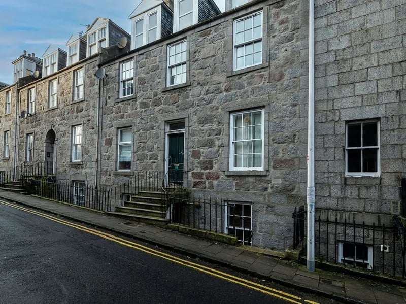 This one bedroom flat close to Aberdeen city centre has been reduced by a total of £27,000 since it was first listed in January 2025, and is now available for offers over £48,000. The 'well-maintained' property with a 'spacious' lounge is described as a buy-to-let opportunity, with a long-term tenant currently living there.