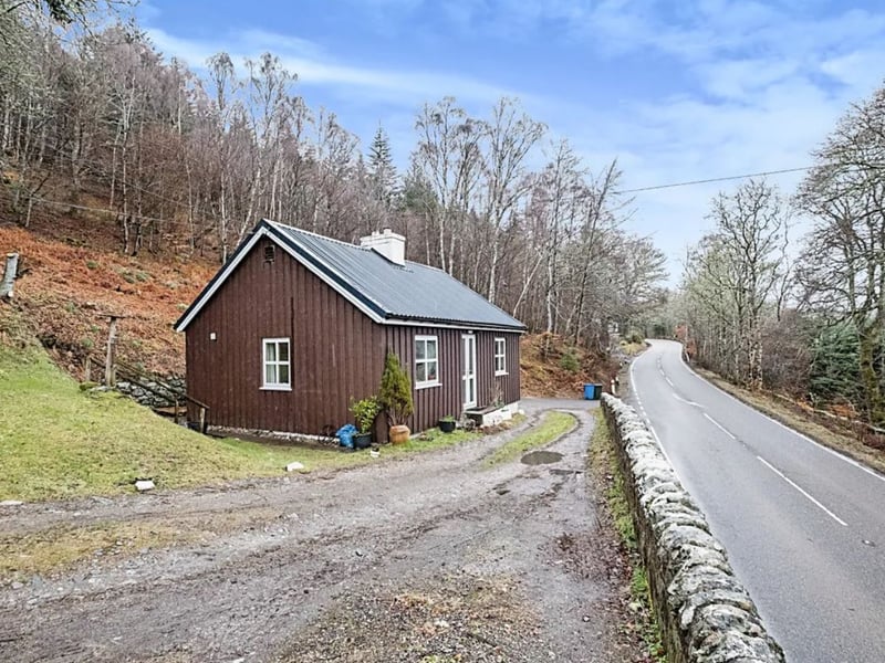 This two-bedroom detached bungalow has been reduced by £55,000 in total and is now listed for sale for offers over £90,000. It is located near the shores of Loch Ness, boasts 'exceptional' views and has a wood burner.