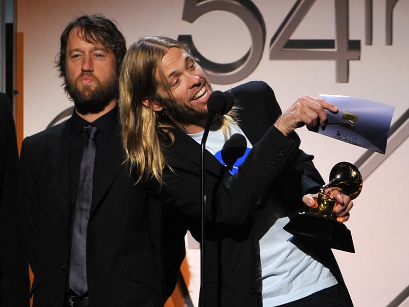 (R-L) Musician Taylor Hawkins and Chris Shiflett of the Foo Fighers accept the award for Best Album for "Wasting Light" onstage at the 54th Annual GRAMMY Awards held at Staples Center on February 12, 2012 in Los Angeles, California.
