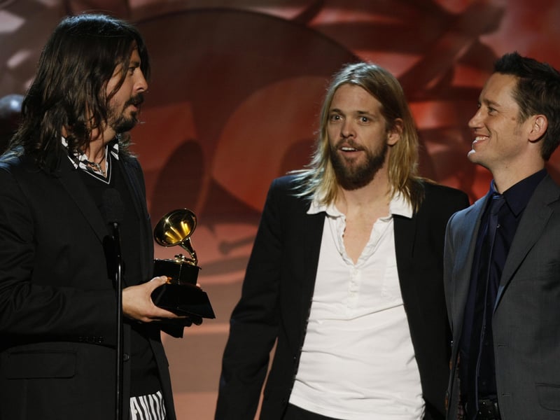David Grohl (L), Taylor Hawkins (C), and Chris Shiflett (R) of the band the Foo Fighters accept the Grammy in the Best Hard Rock Performance category during the Pre-Telecast Show at the 50th Grammy Awards at the Staples Center in Los Angeles on February 10, 2008.