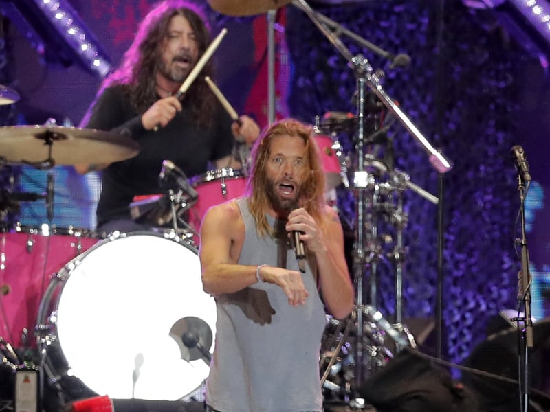 Picture taken on March 18, 2022 of Foo Fighters' drummer Taylor Hawkins and lead singer Dave Grohl on stage, at the Lollapalooza 2022 music festival in Santiago. - Hawkins, 50, of the multi-Grammy award-winning rock group the Foo Fighters has died while on tour in Bogota, Colombia, his bandmates said in a statement on March 25, 2022