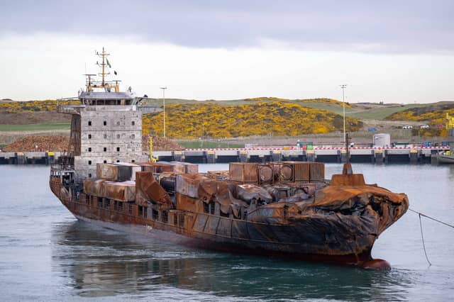 The stricken container ship the Solong, which was involved in a collision with a tanker in the North Sea, is towed in to the port of Aberdeen.