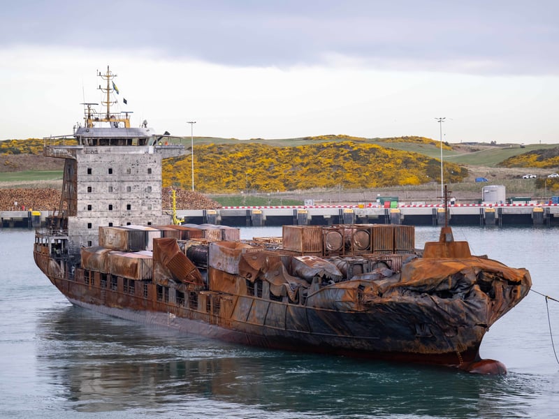 The stricken container ship the Solong, which was involved in a collision with a tanker in the North Sea, is towed in to the port of Aberdeen.