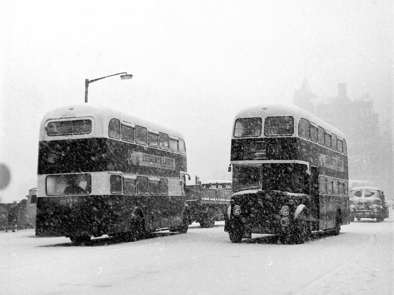 Buses struggle through the blizzard on North Bridge during a snow storm in Edinburgh in April 1968.