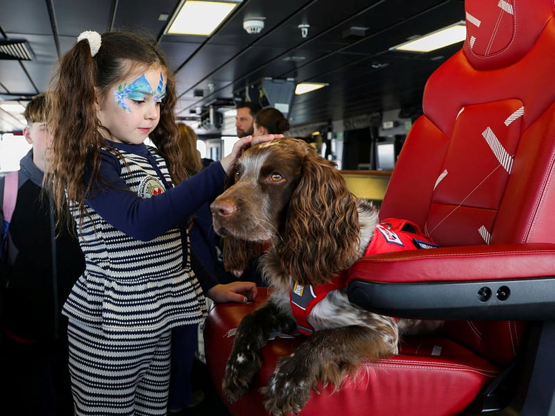 HMS Prince of Wales welcoming families and affiliates on board ahead of Indo-Pacific deployment. Pictured: Family of Lieutenant Smitham with a service dog.