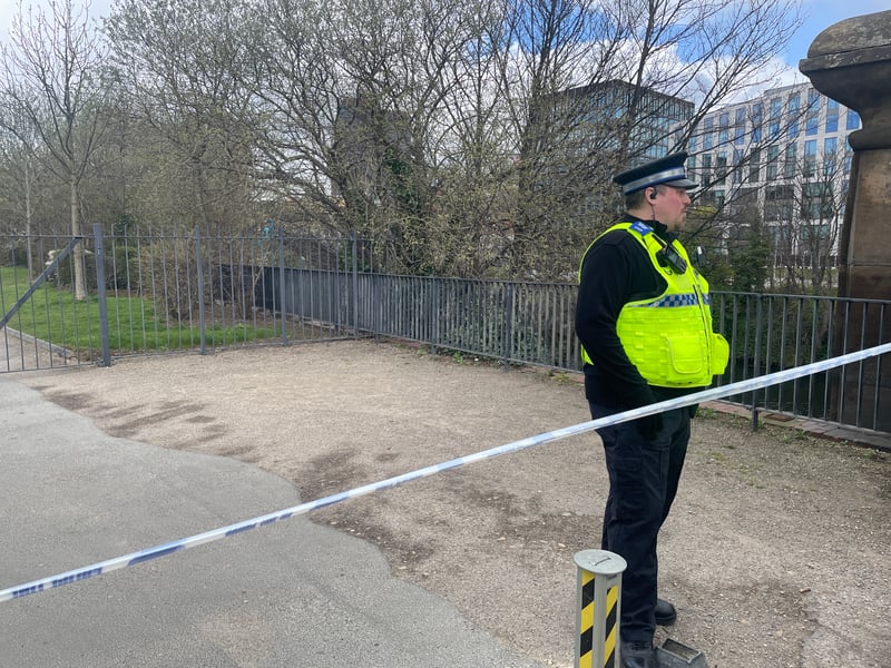 Police remain at the scene guarding the blocked-off entrance.