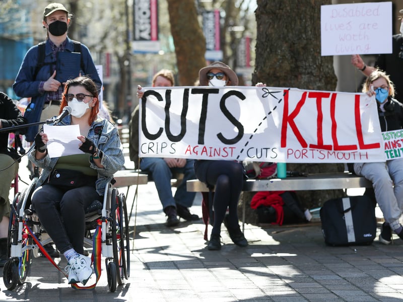 Activist Felix (left) from Crips Against Cuts delivers a speech at Portsmouth Guildhall Square protesting against the government's planned welfare cuts. Picture: 
Nathan Lipsham