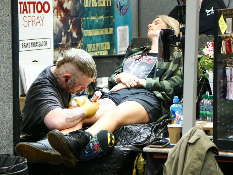 Tattoo artist at work. Picture: Nathan Lipsham