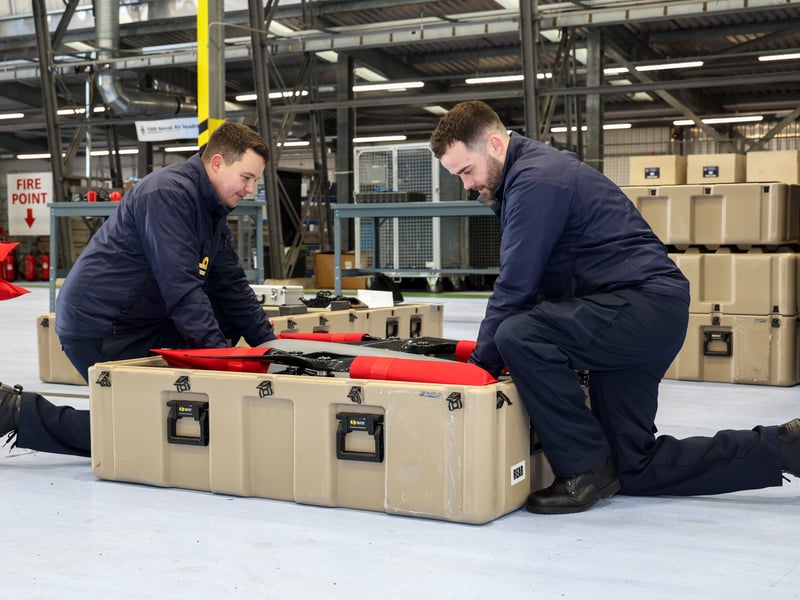 Pictured: Members of the drone unit team packing the Malloy T-150 drone away.