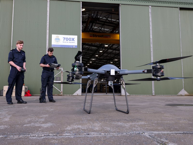 Pictured: (L/R) Able Rate Michael Page and Lieutenant Matthew Parfitt of 700X NAS, testing on one of the squadron's Malloy T-150 drones.