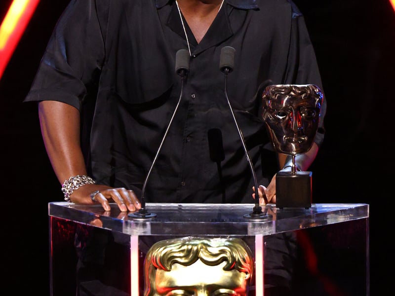 Abubakar Salim accepts the Game Beyond Entertainment Award on behalf of the Development Team for 'Tales of Kenzera: ZAU' on stage during the BAFTA Games Awards 2025.
