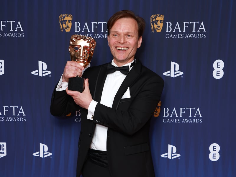 Alec Newman poses in the winners with the Performer in a Leading Role Award for the portrayal of Caz in 'Still Wakes the Deep' room during the BAFTA Games Awards 2025.