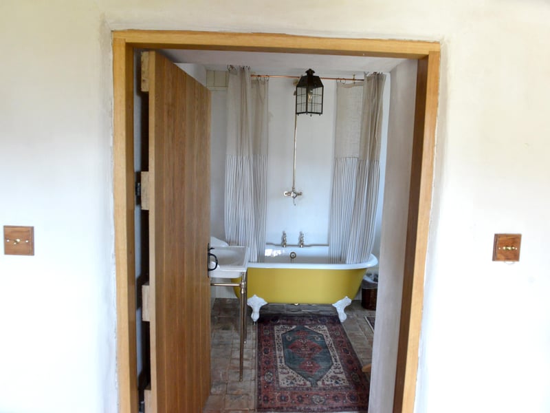 Indoor bathrooms wouldn't be in many homes until the later Victorian period, with the bathrooms in the cottages including roll top baths and Delft tiles more similar to that period.