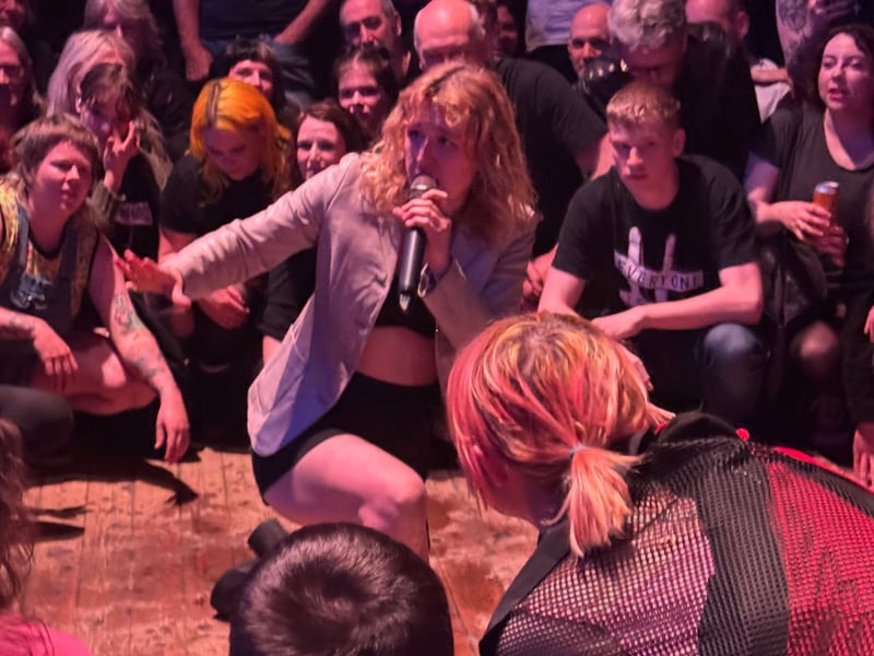 The crowd are urged to go lower - before exploding into a circle pit.