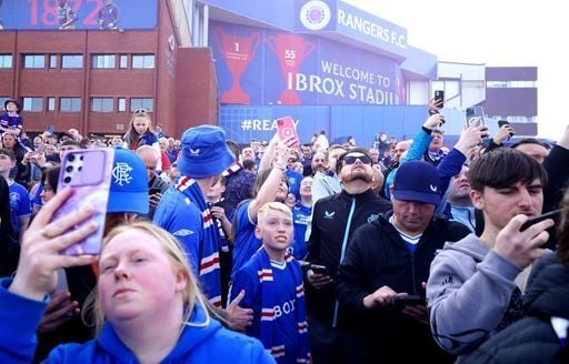 Rangers fans welcome to the team to Ibrox before the game.