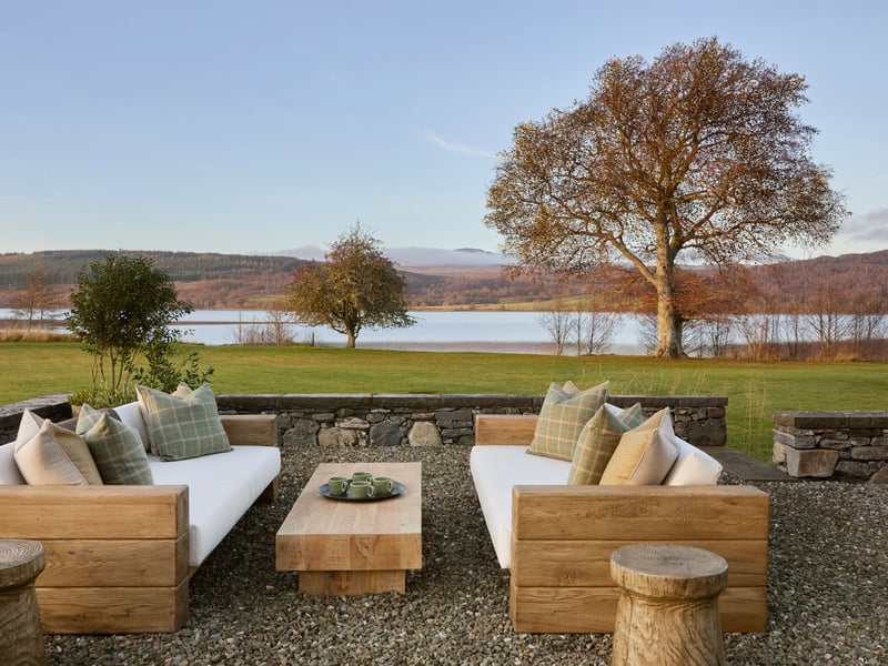 The exterior seating area and view from the Omaze Million Pound House Draw property on the shores of Loch Rannoch in Perthshire.