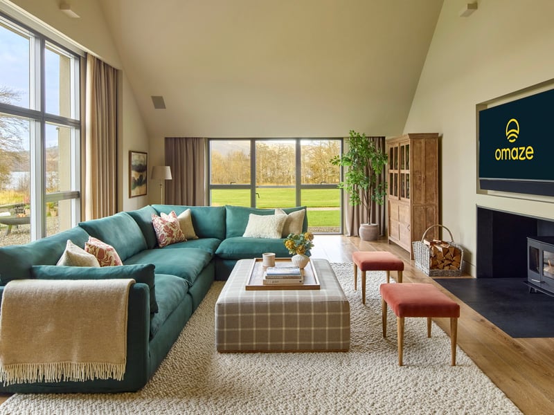 The living room with large-screen TV inside the Omaze Million Pound House Draw property on the shores of Loch Rannoch in Perthshire