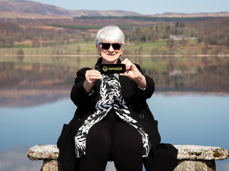 Patricia Moule, the 81-year-old Omaze Winner, outside her new £4 million home in Scotland.