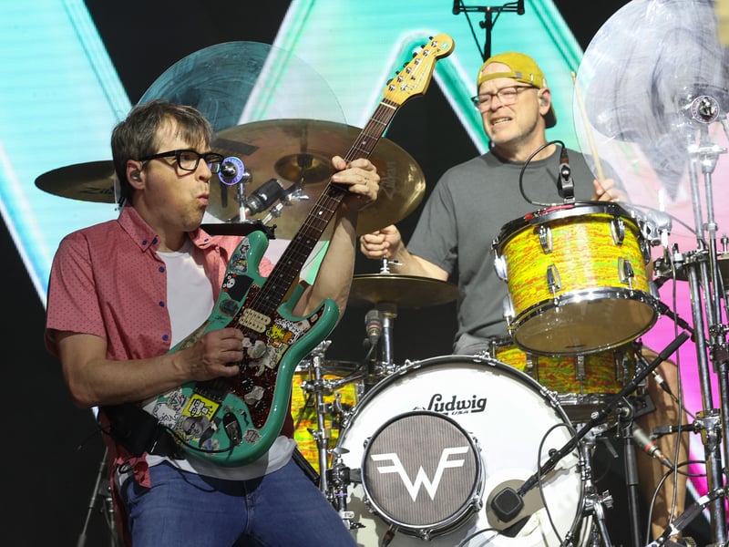 US musicians Rivers Cuomo (L) and Patrick Wilson from Weezer perform during the 2025 Coachella Valley Music and Arts Festival at Empire Polo Club on April 12, 2025 in Indio, California.