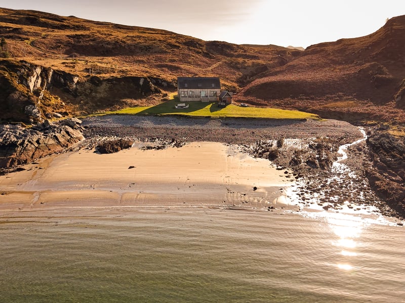 The off-grid property, which has its own green energy supply, is set within around two acres of its own land, which includes the shorefront. Water is part of life at Doune Bay and the house comes with a boathouse and a separate workshop at the back of the property, which has its own shower.