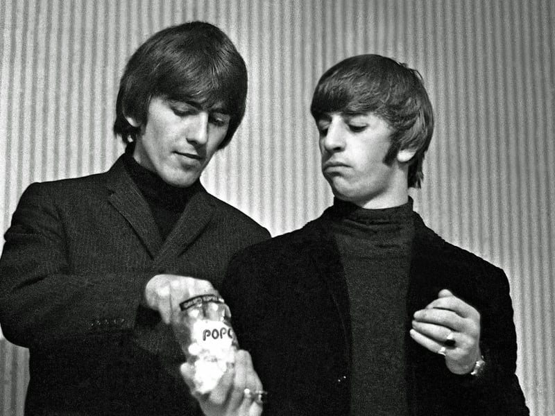 George Harrison and Ringo Starr enjoy a packet of popcorn prior to The Beatles concert at the Odeon Theatre in Leeds on October 22, 1964. Mr Berriff said that the two men were quieter than John Lennon and Paul McCartney.
