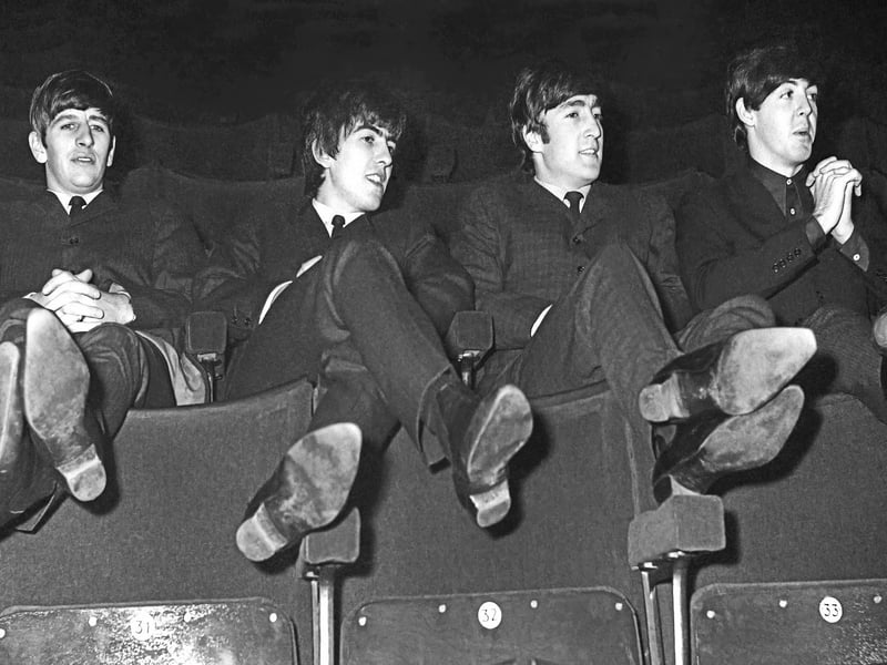 The Beatles relax in the auditorium of the ABC Theatre in Huddersfield. Mr Berriff told a remarkable story of how he attended the show early with his girlfriend and watched the band soundcheck by playing their new song, 'I Want To Hold Your Hand'.