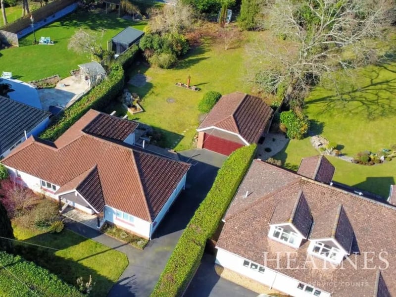 This three-bedroom detached bungalow boasts a 'superb' garden stretching back 230 feet, with a patio, large lawn, pond, log store, greenhouse, trees and shrubs. It's handily located on Glendale Avenue, just 900 metres from Ferndown town centre in Dorset, and is listed for sale with Hearnes, with a guide price of £675,000.
