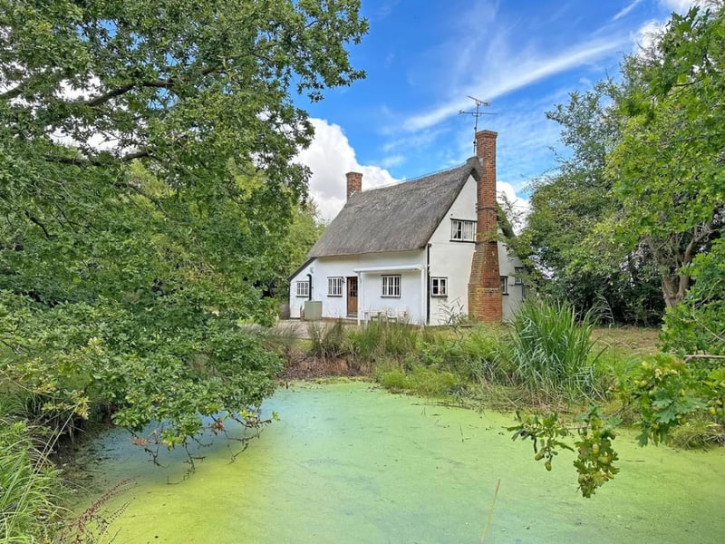 This 'chocolate box' pretty two-bedroom cottage is set on a 2.1-acre plot with a stunning garden. The wildlife haven includes a lovely feature pond with lilies and reeds which can be enjoyed from the brick patio at the rear of the house. Grays Cottage, on Grays Lane, Wethersfield, Essex, is listed for sale with eXp World UK and has a £650,000 guide price.