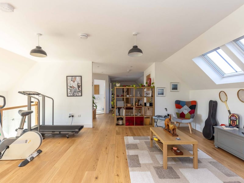 Climbing the stairs takes you to a stunning mezzanine landing that offers plenty of additional space to create a further seating area, potentially a less formal family area for children. Part of the landing overlooks the sitting room below and is currently utilised as a gym area, taking advantage of the stunning views.