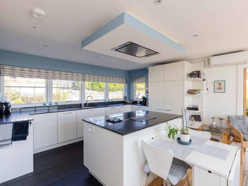 To the other end of the room, you find a high-spec Leicht kitchen by Kitchens International which is fitted with high-quality Siemens appliances.