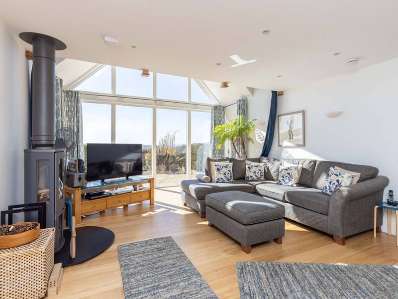 The accommodation is focused on a stunning dual-aspect kitchen and living room that boasts huge levels of natural light and stunning views towards the Pentlands. A contemporary log burner creates a natural focal point for the seating area.