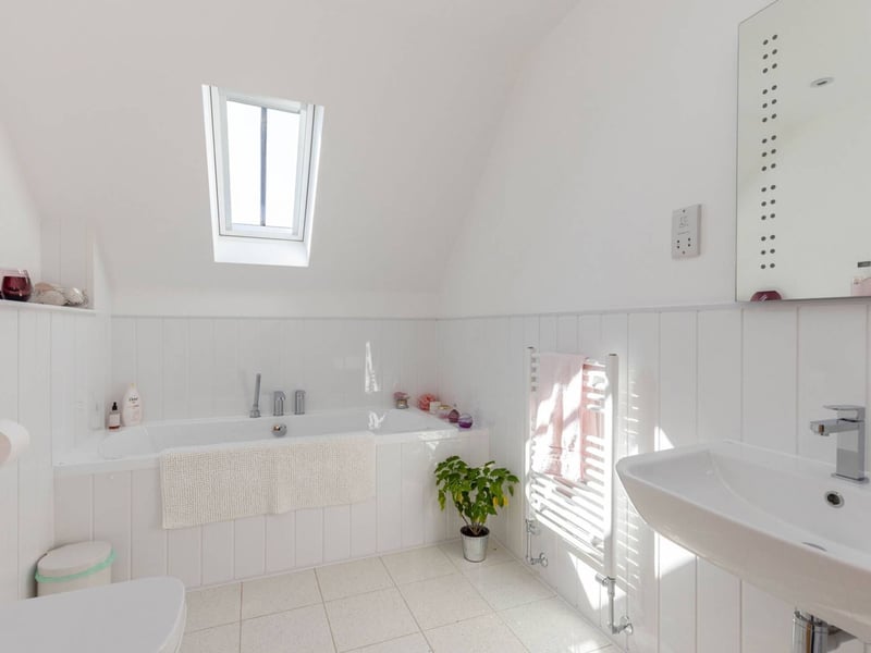 The Midlothian property's bright and airy family bathroom.