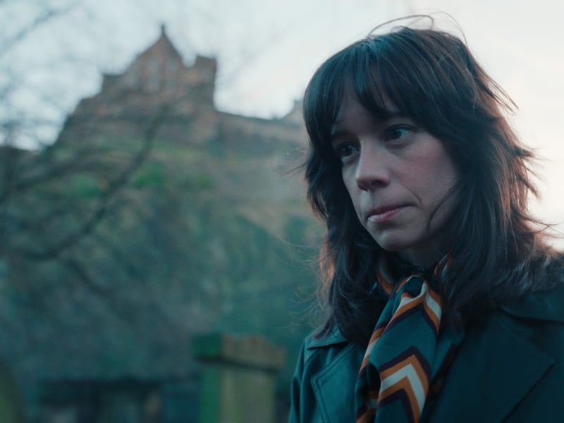 Pivital character Merrit Lingard, played by Chloe Pirrie, in a tense scene at St John's Churchyard at Princes Street in the shadows of Edinburgh Castle.