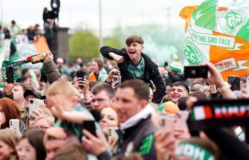 Celtic fans celebrate victory in the Premiership outside Celtic Park.